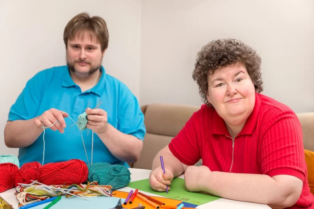 Two disabled friends in art class