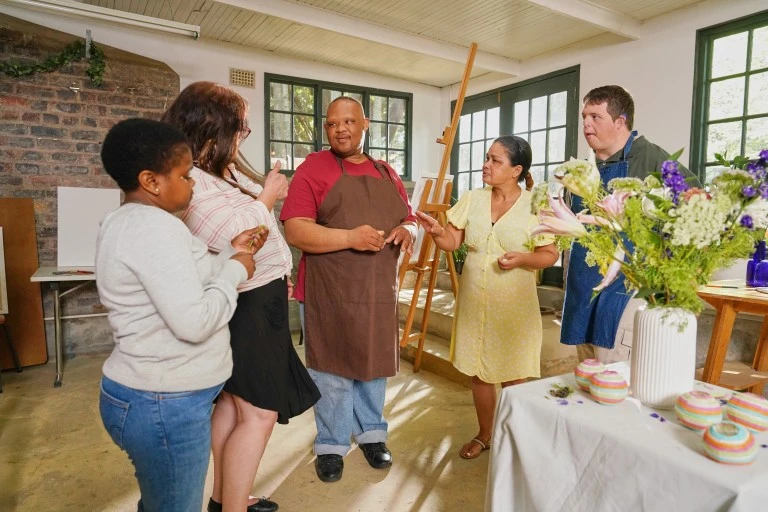 Five disabled friends talking in art class