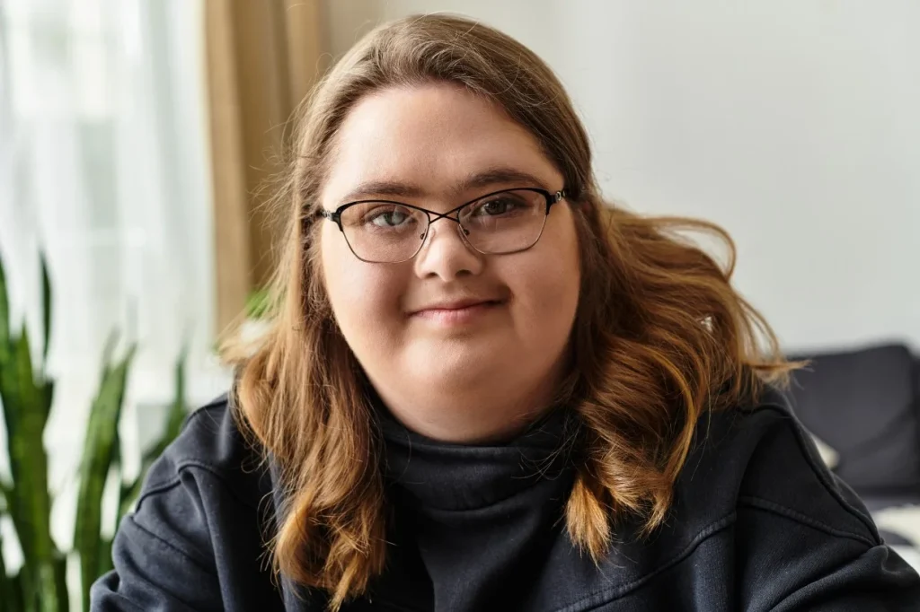 Disabled woman with down syndrome smiling at camera