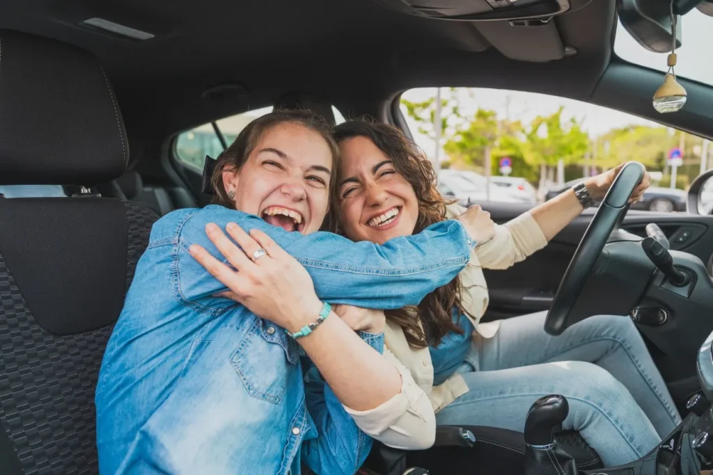 Disabled woman in car with support worker